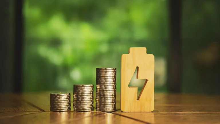 pile of coins and an electricity symbol